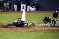 September 19 2015: Toronto Blue Jays Third base Josh Donaldson (20) [7086] dives to make home plate to score off Toronto Blue Jays Designated hitter Edwin Encarnacion (10) [4352] RBI in the eighth inning during 7 - 6 loss against Boston Red Sox in the eighth inning at Rogers Centre in Toronto, ON, Canada.