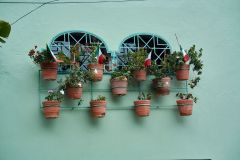 Mexican flags in flower pots outside windows in Ajijic to celebrate Mexican Independence day (September 16)