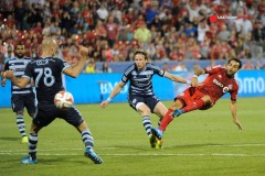 zJul 26, 2014; Toronto, Ontario, CAN; Toronto FC mid-fielder Dwayne De Rosario (14) shoots past Sporting KC forward Jacob Peterson (37) and defender Aurelien Collin (78) in second half at BMO Field - Sporting KC beat Toronto FC 2 - 1 Mandatory Credit: Peter Llewellyn-USA TODAY Sports