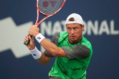 Aug 4, 2014; Toronto, Ontario, Canada; Lleyton Hewitt (AUS) plays a backhand against Julien Benneteau (FRA) in the 1st round of The Rogers Cup at Rexall Centre. Mandatory Credit: Peter Llewellyn-USA TODAY Sports