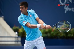 Aug 6, 2014; Toronto, Ontario, Canada; Novak Djokovic (SRB) plays a backhand against Gael Monfils (FRA)  on day three of the Rogers Cup tennis tournament at Rexall Centre. Mandatory Credit: Peter Llewellyn-USA TODAY Sports