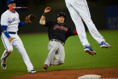 Aug 31, 2015; Toronto, Ontario, CAN; Cleveland Indians catcher Yan Gomes slides to third before scoring on a fielding error by Toronto Blue Jays third baseman Josh Donaldson (20) in the ninth inning at Rogers Centre. Indians beat Jay 4 - 2. Mandatory Credit: Peter Llewellyn-USA TODAY Sports
