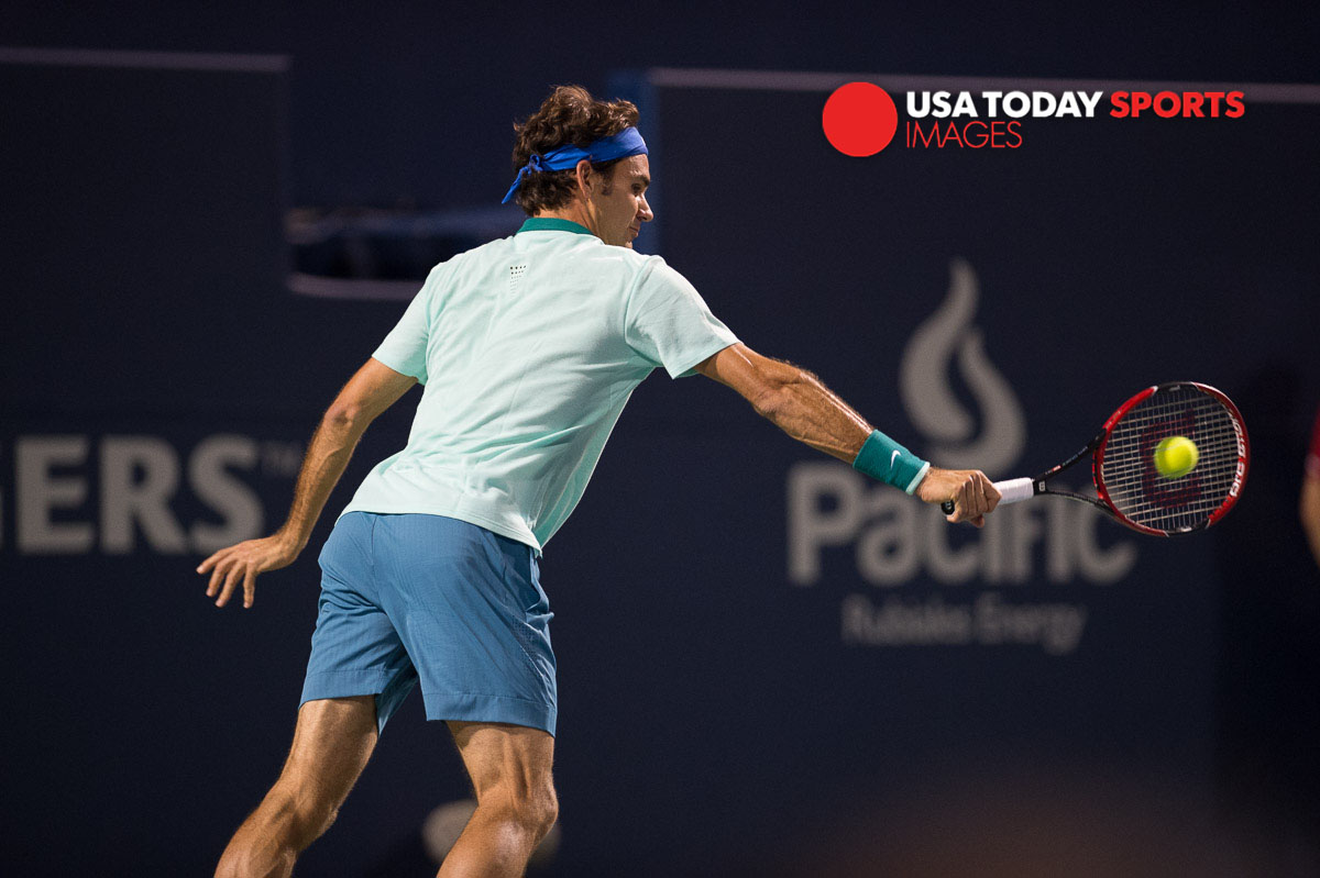 1Aug 8, 2014; Toronto, Ontario, Canada; Roger Federer (SUI) plays a backhand against David Ferrer (ESP) on day five of the Rogers Cup tennis tournament at Rexall Centre. Mandatory Credit: Peter Llewellyn-USA TODAY Sports