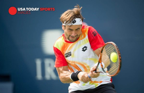 Aug 7, 2014; Toronto, Ontario, Canada; David Ferrer (ESP) hits a backhand against Ivan Dodig (CRO) on day four of the Rogers Cup tennis tournament at Rexall Centre. . Mandatory Credit: Peter Llewellyn-USA TODAY Sports